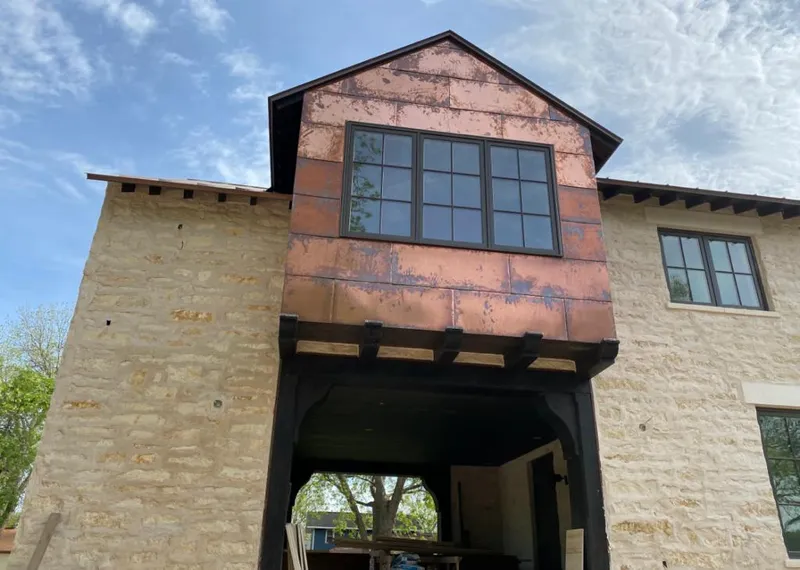Copper metal panel facade on a stone building for Skylight Installation in Florissant